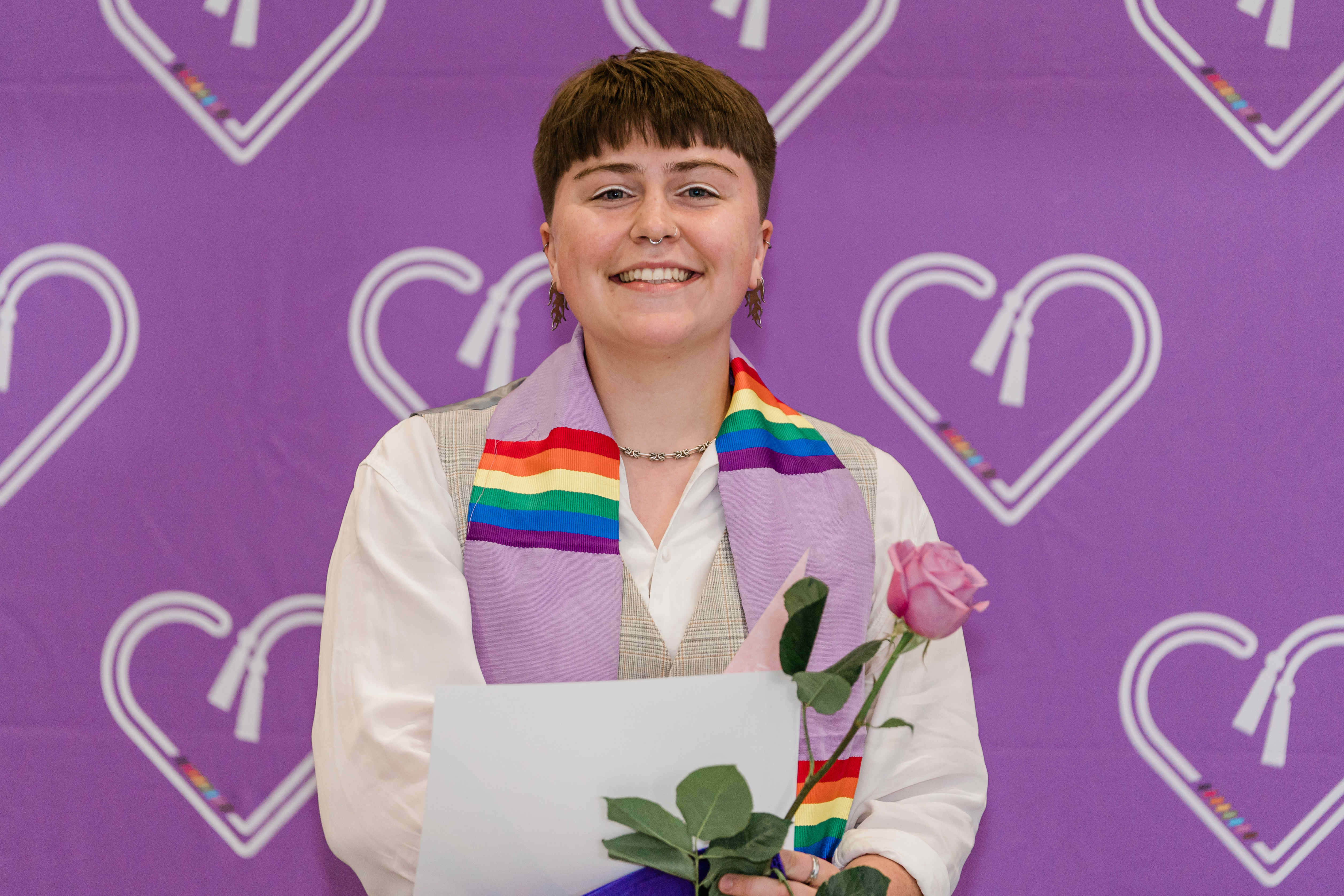 Graduate in front of backdrop